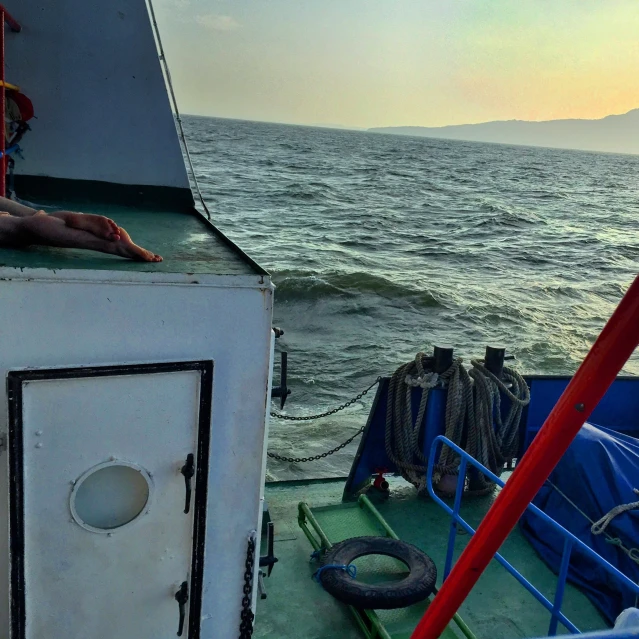 view from the deck of a boat near water with life jackets on