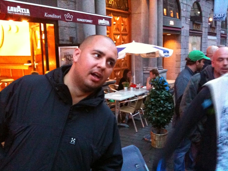 a man standing in front of a group of people on a street