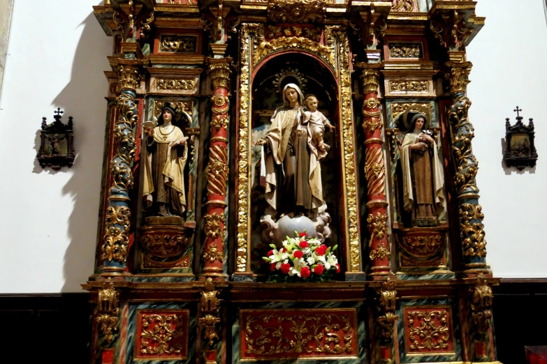 a statue of the virgin mary on the altar