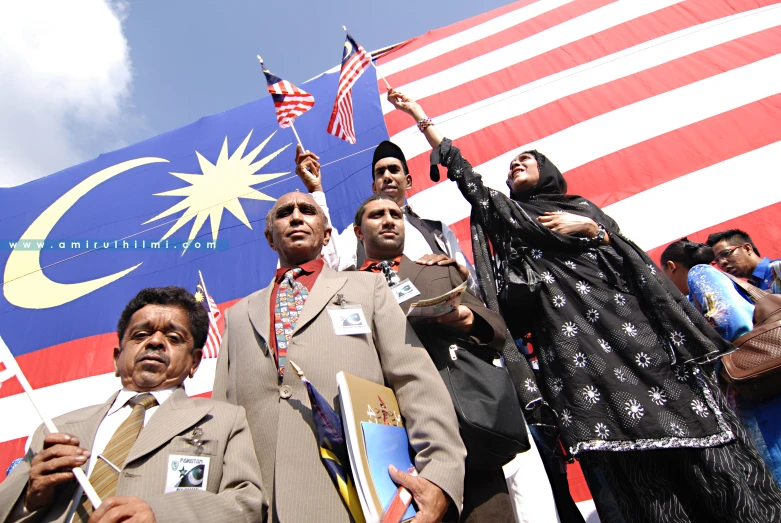 people are standing in front of an american flag