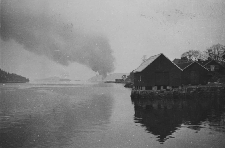 black and white po of large exhaust pipe on a body of water