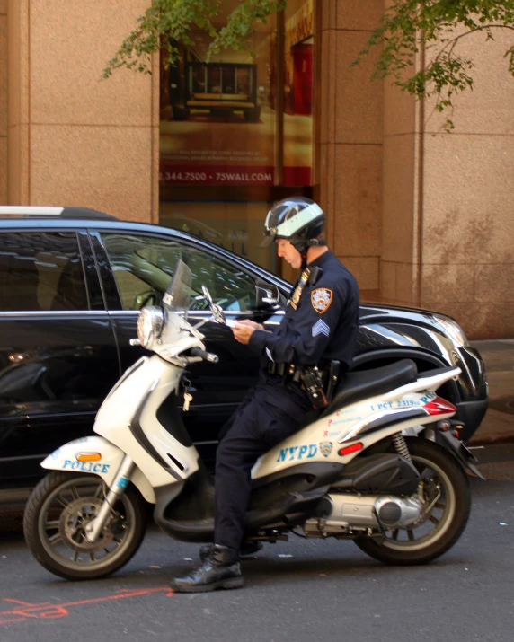 a police officer is sitting on his motorcycle