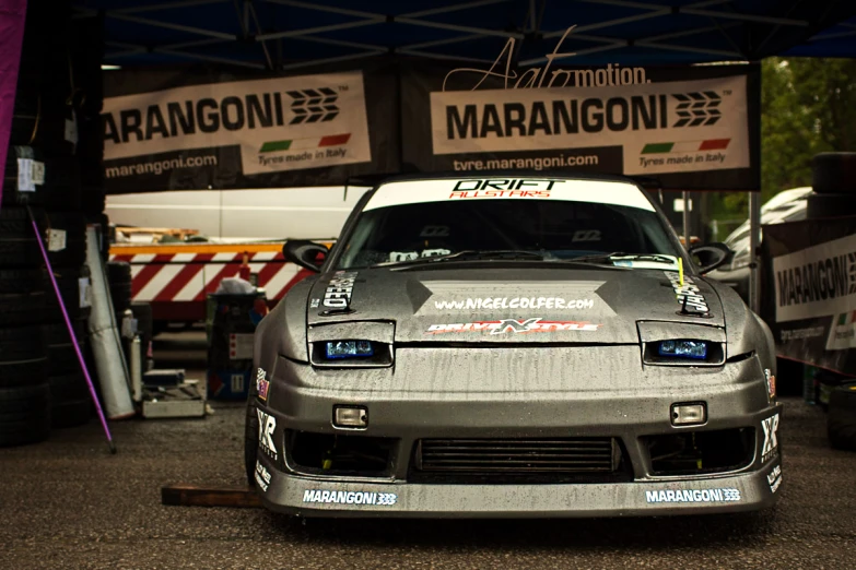 a car parked under a canopy in a garage