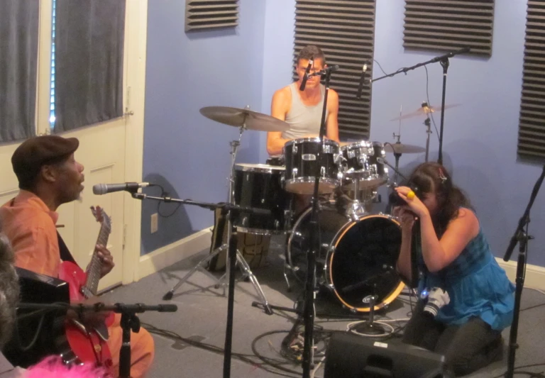 a woman sitting on a chair playing the drums