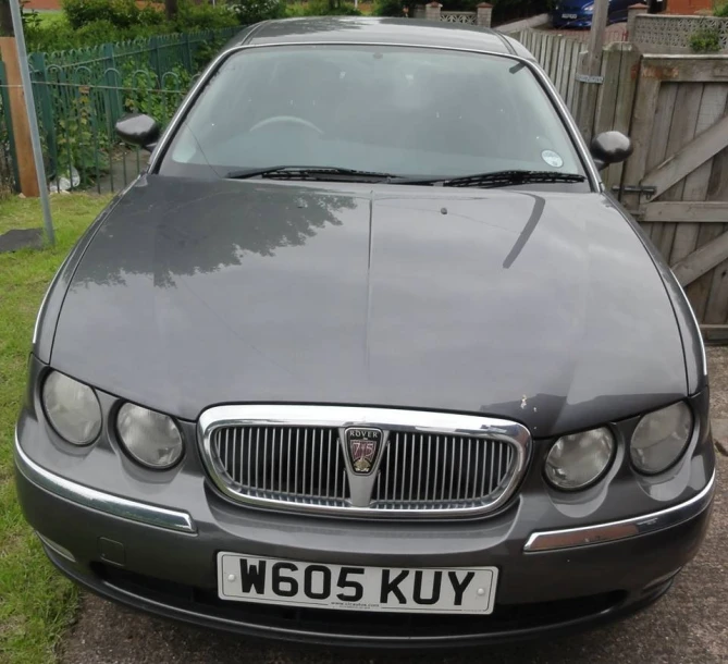 a picture of a grey car sitting in the driveway