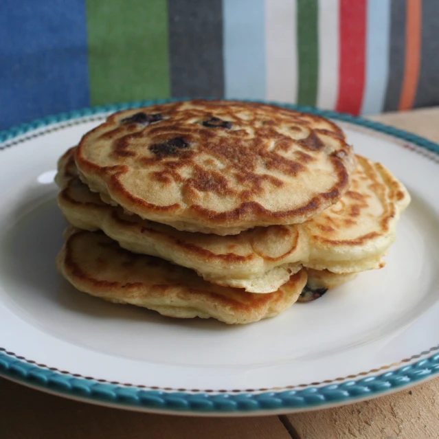 the stack of pancakes has blueberries on it