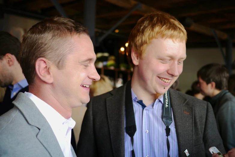 a close up of two men in suits