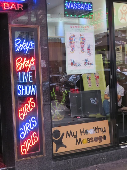 a brightly lit store with neon signs outside of it