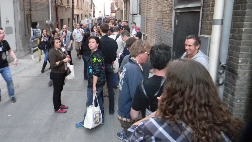 people walk down a city street in a crowded area