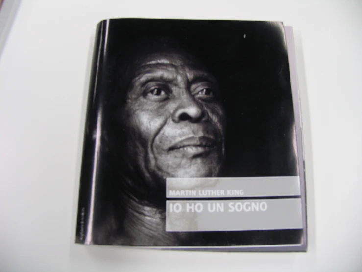 a black and white po of a man's face is in an open book