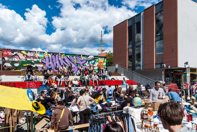 a group of people standing in front of a building with lots of art