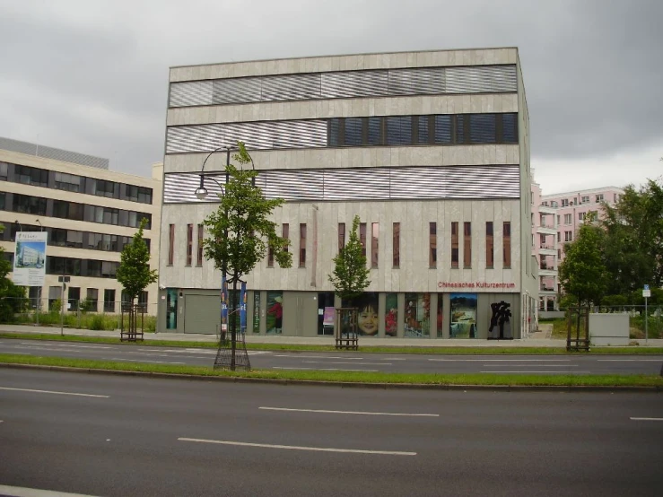 there are two buildings, one with a man on a bicycle