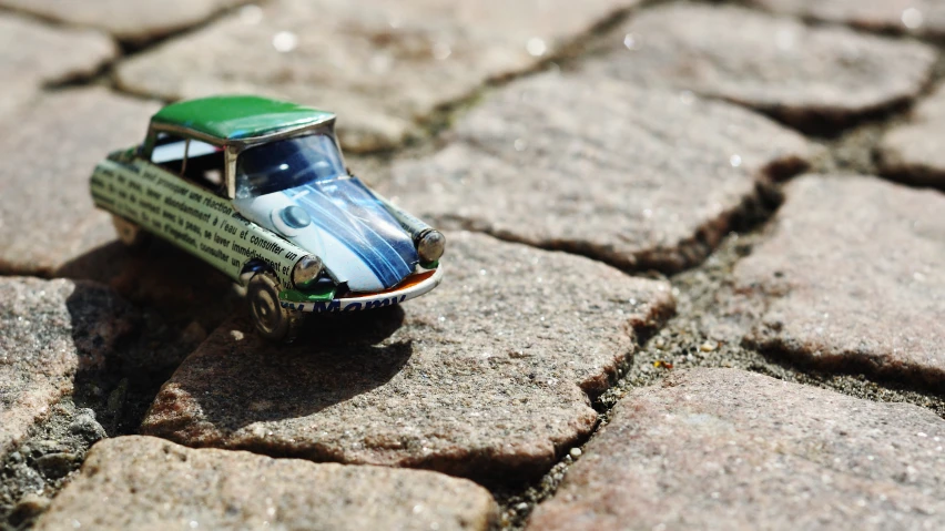 a toy car sitting on stone blocks looking like it has an advertit for a book