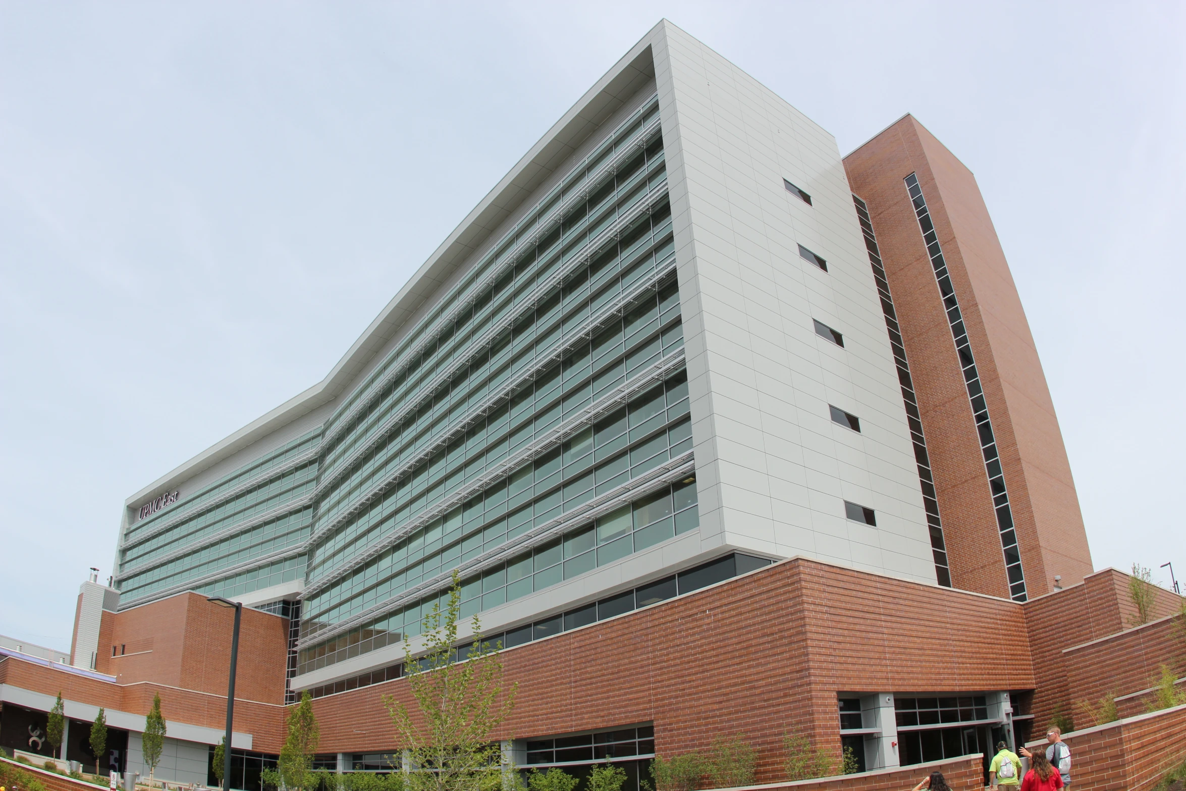 a tall building with many windows next to a path