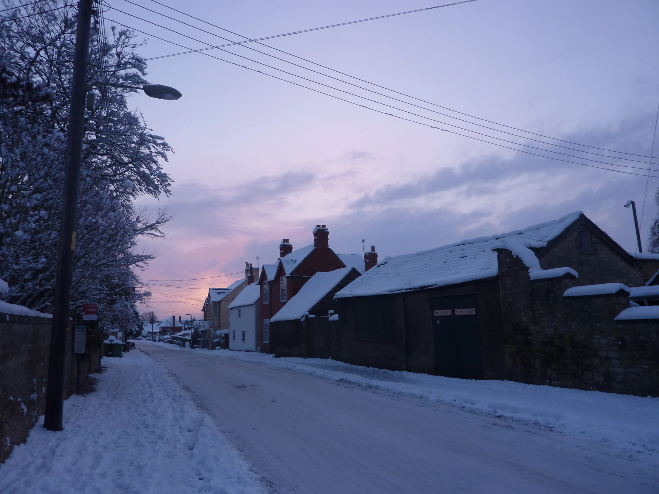 a small road in a town covered in snow