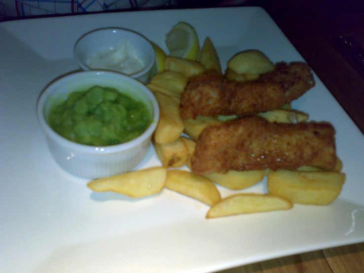 some fish fries and a small bowl of green churnish