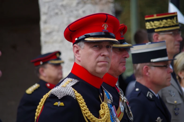 three uniformed men in uniform stand next to each other