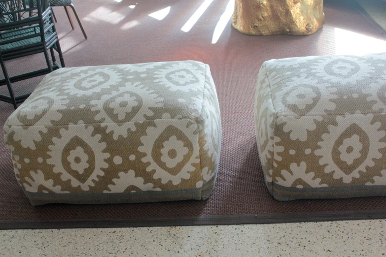 a couple of ottomans sitting on top of a carpeted floor