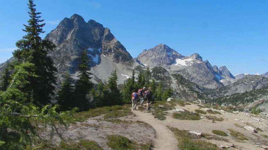 hikers are hiking the trail in the mountains