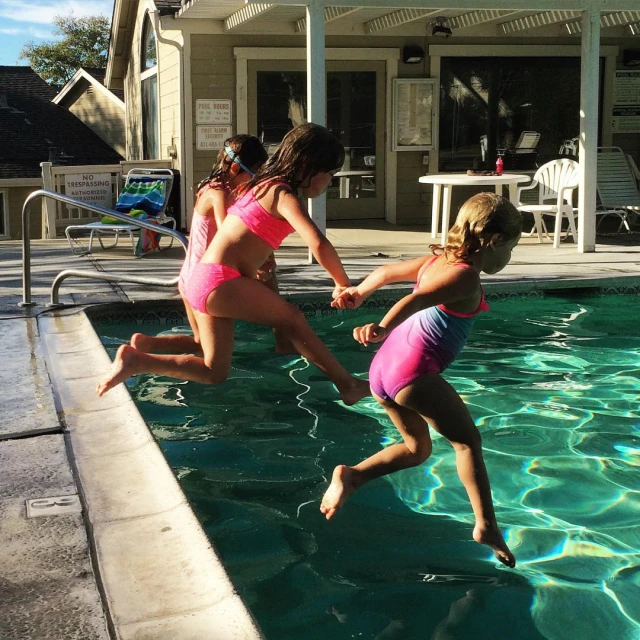 two girls playing in the pool of their home