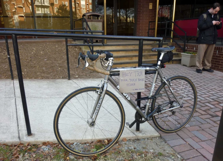 a bike sitting outside a shop with the front wheel missing