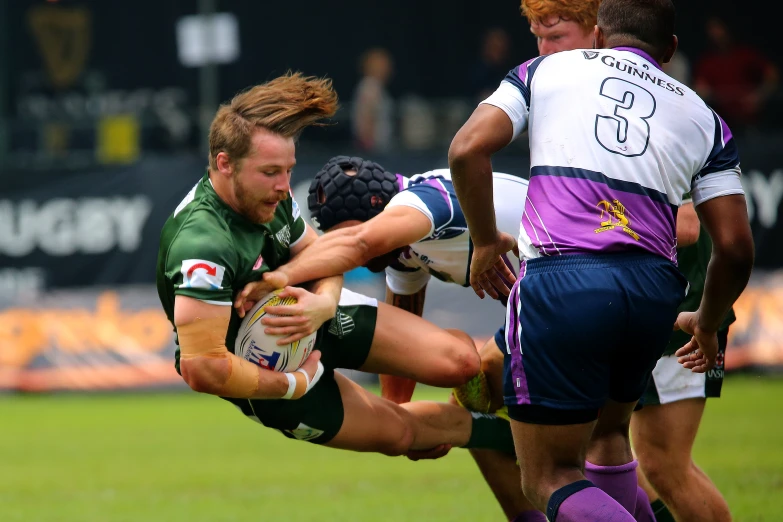 a rugby player gets hit by an opponent