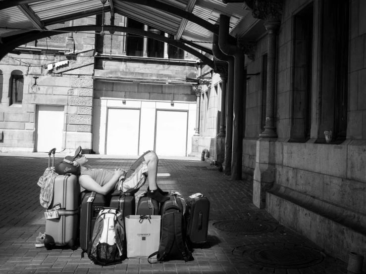 a woman laying down with several luggage behind her