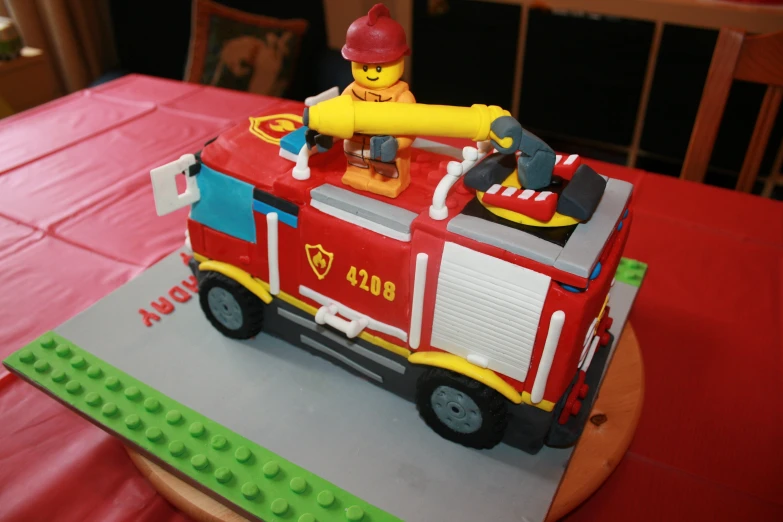 the cake has fire trucks on it