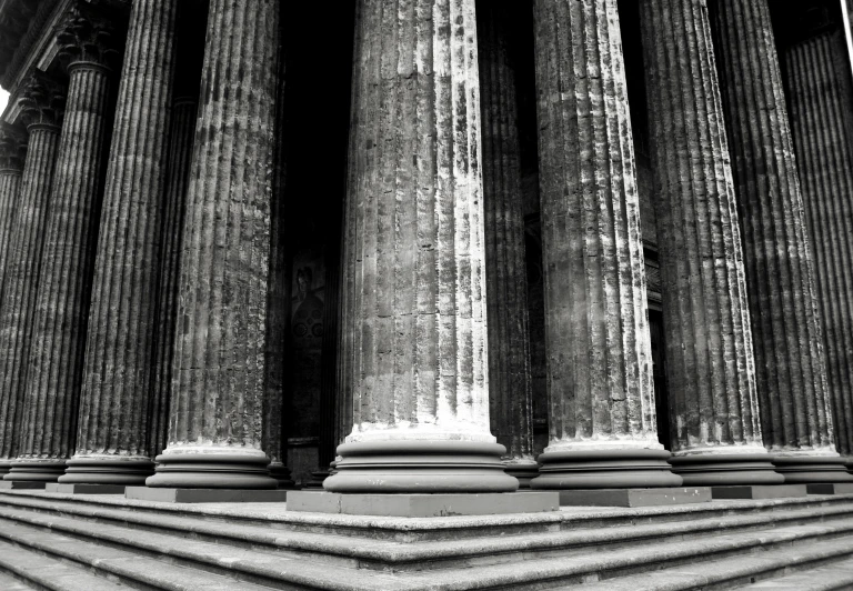 a row of columns with lights shining on them