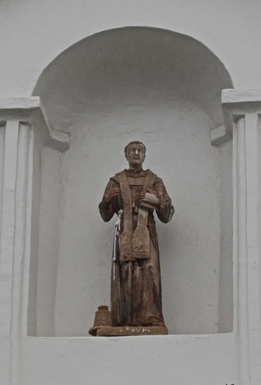 a statue of a man standing in a doorway