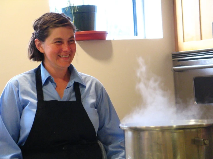 a women who is cooking some food near a pot