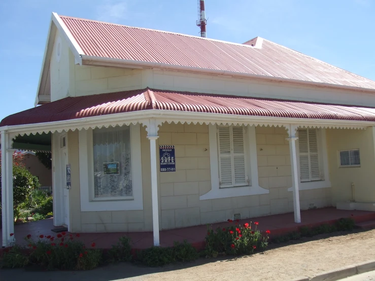 a white house that has a red roof