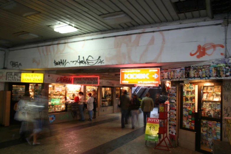 the people walk past the market where food is on sale