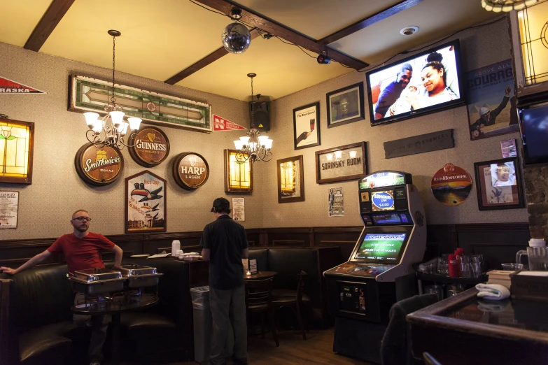 some guys at a restaraunt playing video games