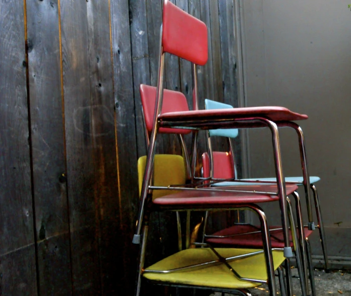 many chairs lined up in a row against a wall