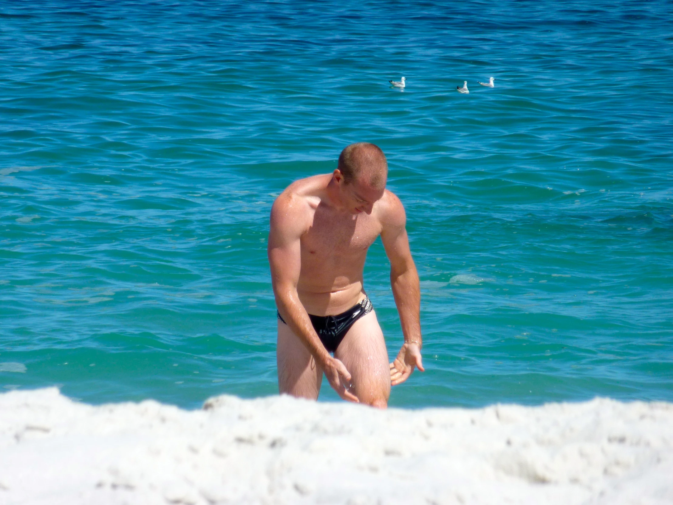 a man that is standing up in the sand