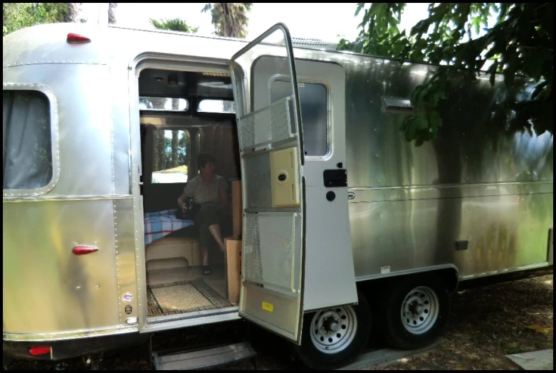 an open door to a metal trailer with the door opened