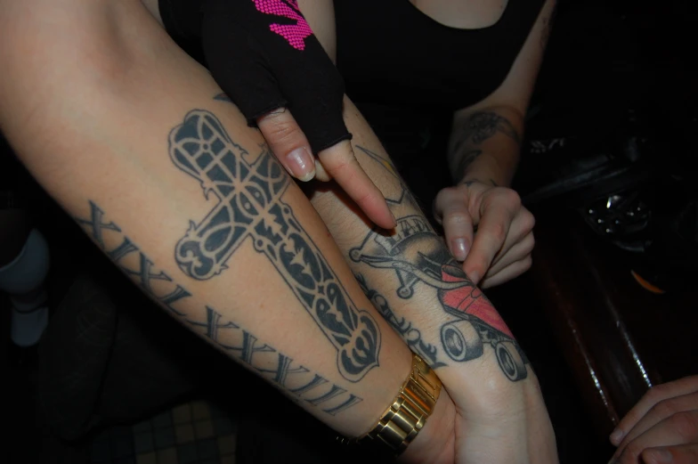 a close up of a person with arm tattoos