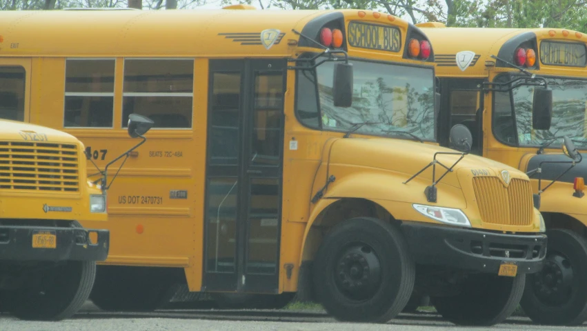 three school buses parked next to each other