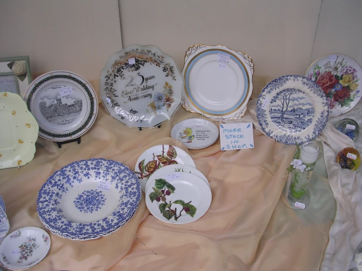 a table with porcelain plates and cups on display