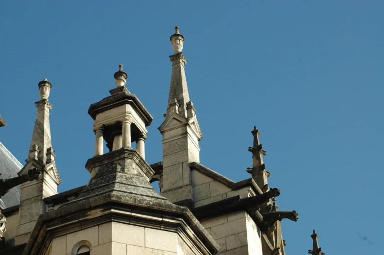 the tops of several spires on an old church