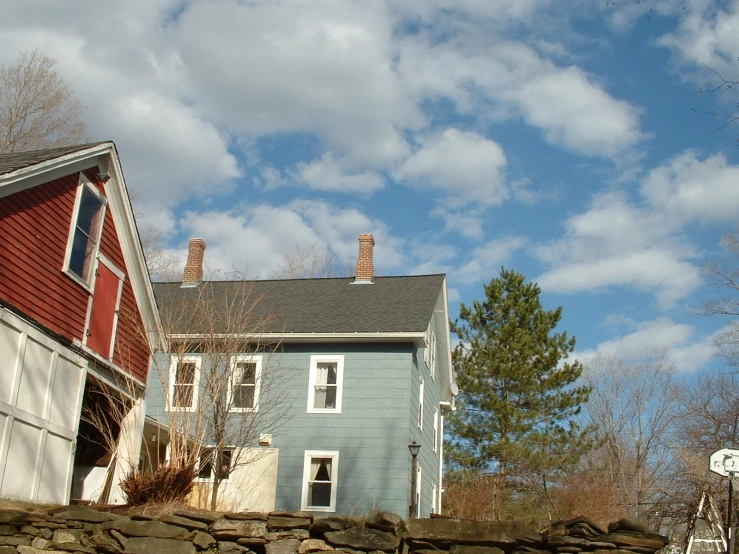 the house is grey and red with brown trim