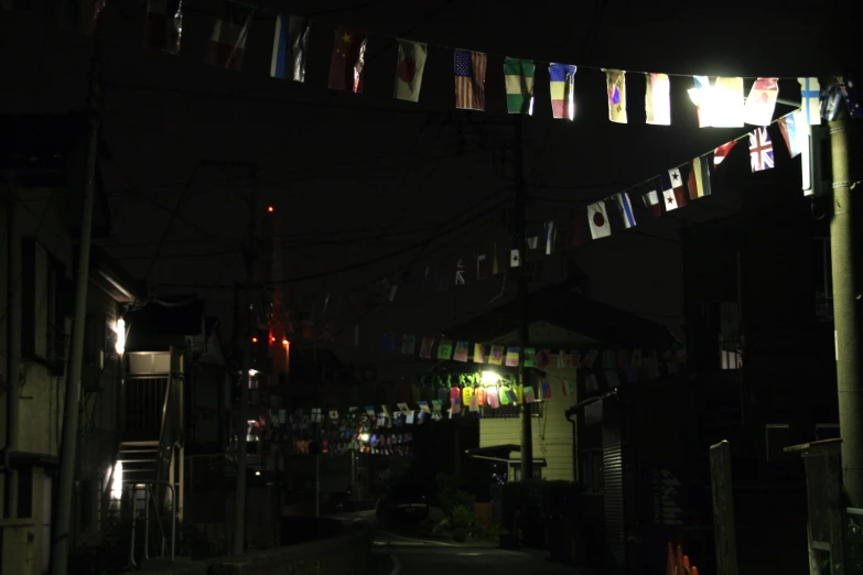 there are some flags above a street at night