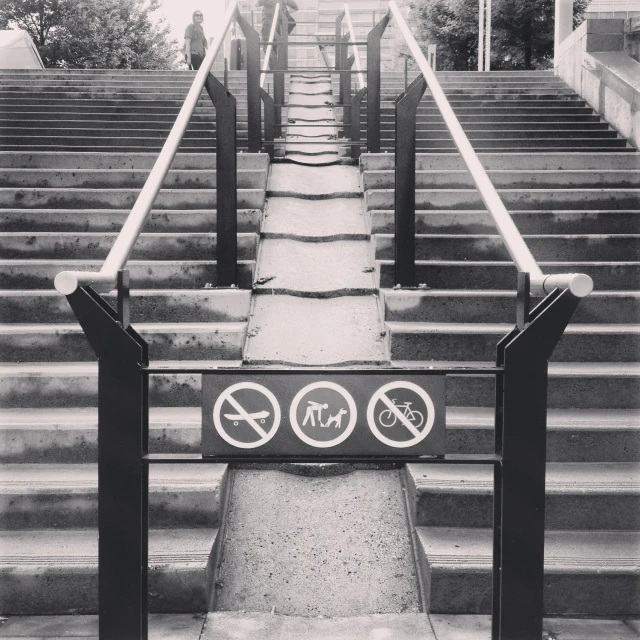 black and white pograph of a staircase and banisters with signs