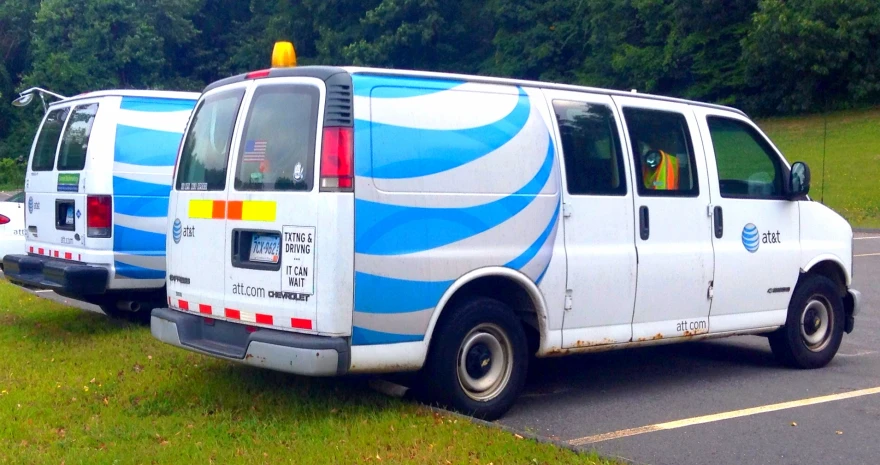 two water vans are parked in a parking lot