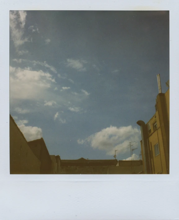 a sky with clouds and buildings in it