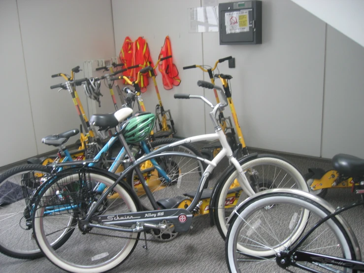 there is a row of bike rackes in a bike storage room