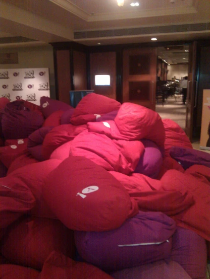 a huge pile of red and purple mattresses