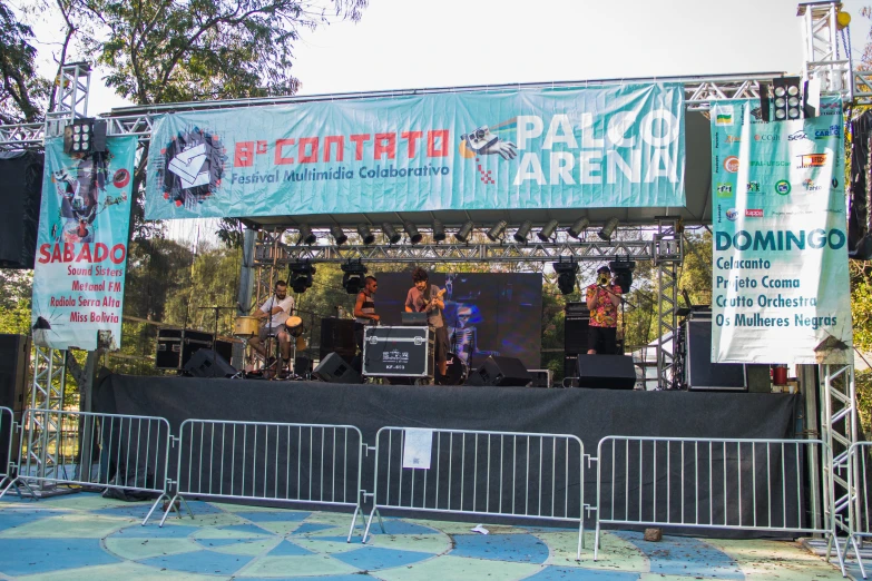 a concert scene, with banners and a stage behind it