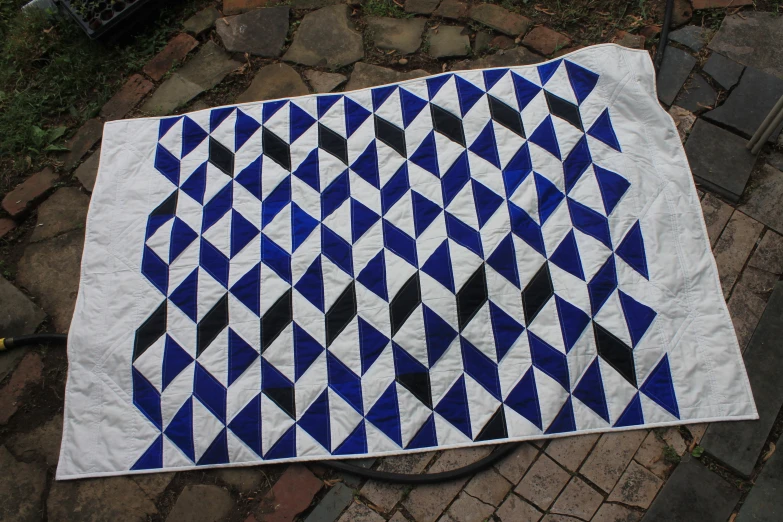 a very large quilt is laying on the ground